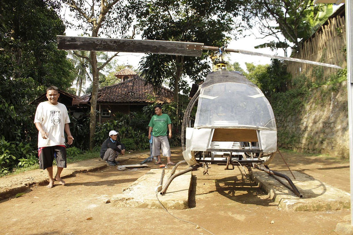 Jujun Junaedi spends days off in the backyard tinkering with the do-it-yourself chopper -- guided by online instructional videos -- as he dreams of flying over jams in his hometown Sukabumi. Photo: AFP