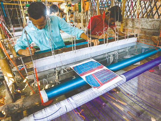 Artisans work on their pit looms to weave Jamdani at Jamdanipalli in Rupganj, Narayanganj on 29 November 2019. Photo: Hasan Raja