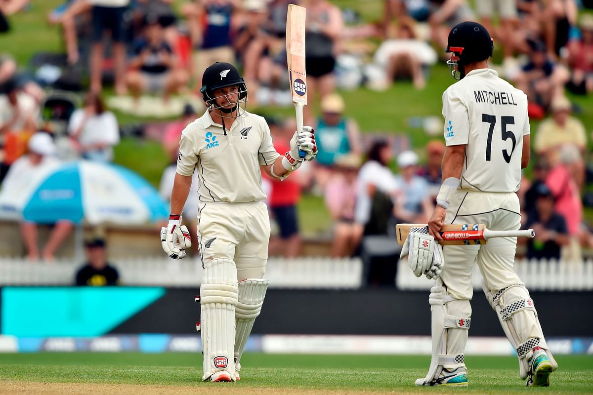 New Zealand`s batsman BJ Watling (L) celebrates after scoring a half-century (50 runs) with a teammate Daryl Mitchell on day two of the second cricket Test match between England and New Zealand at Seddon Park in Hamilton on 30 November, 2019. Photo: AFP