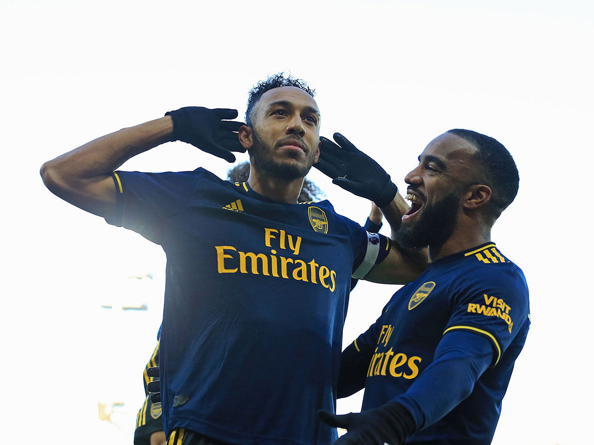 Arsenal`s Gabonese striker Pierre-Emerick Aubameyang (L) celebrates with Arsenal`s French striker Alexandre Lacazette (R) after scoring their first goal from the penalty spot during the English Premier League football match between Norwich City and Arsenal at Carrow Road in Norwich, eastern England on Sunday. Photo: AFP