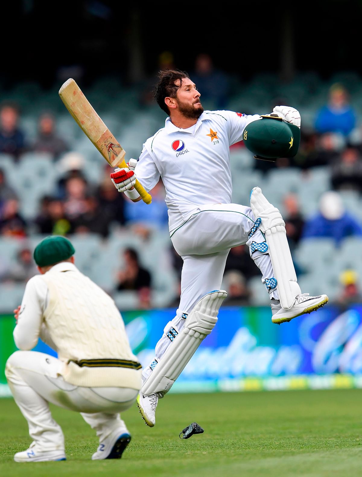 Pakistan batsman Yasir Shah celebrates scoring his century against Australia on the third day of the second cricket Test match in Adelaide on 1 December 2019. Photo: AFP