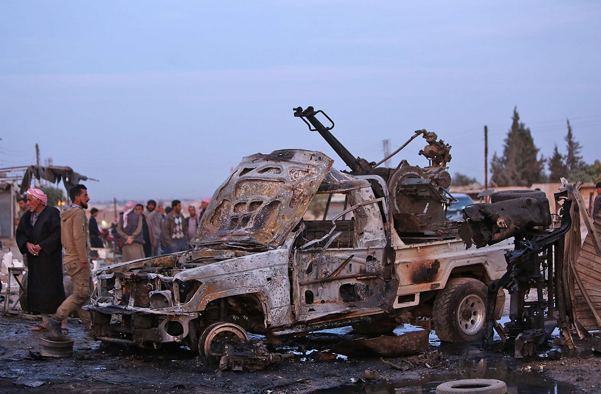 A picture taken on 26 November 2019 shows destroyed vehicles following a car bomb attack at a local market in the Turkish-held Syrian Kurdish town of Tel Hal along the border with Turkey in the northeastern Hassakeh province. Photo: AFP