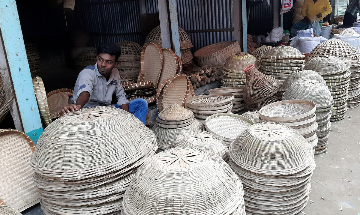 A shopper sits amid handicrafts at Charigram, Singair in Manikganj on 25 November 2019. Photo: Abdul Momin