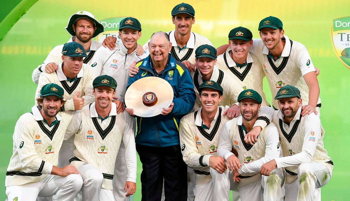 The Australian team celebrates with the trophy after Australia defeated Pakistan on the fourth day of the second cricket Test match in Adelaide on 2 December, 2019. Photo: AFP