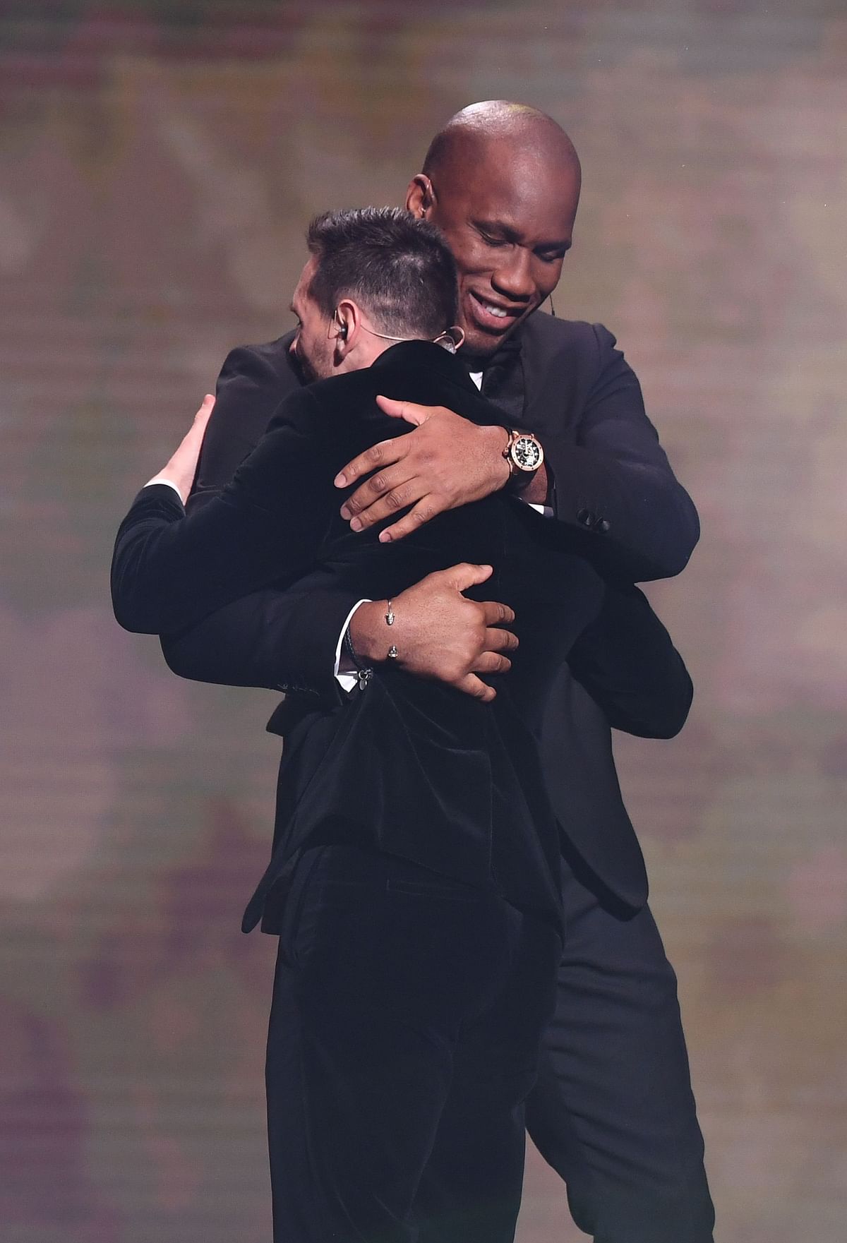 Former Ivorian forward Didier Drogba (R) hugs Barcelona`s Argentinian forward Lionel Messi during the Ballon d`Or France Football 2019 ceremony at the Chatelet Theatre in Paris on 2 December 2019. Photo: AFP