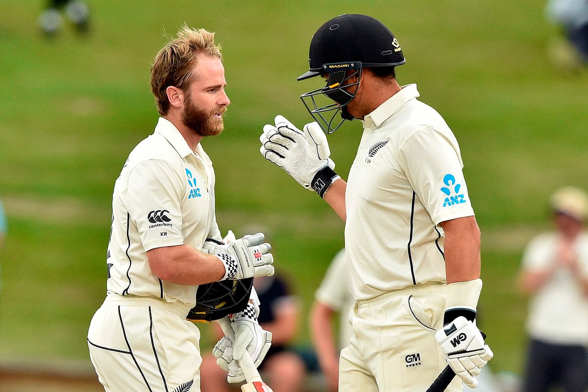 New Zealand`s captain Kane Williamson (L) celebrates reaching his century (100 runs) with a teammate Ross Taylor during the fifth day of the second cricket Test match between England and New Zealand at Seddon Park in Hamilton on December 3, 2019. Photo: AFP