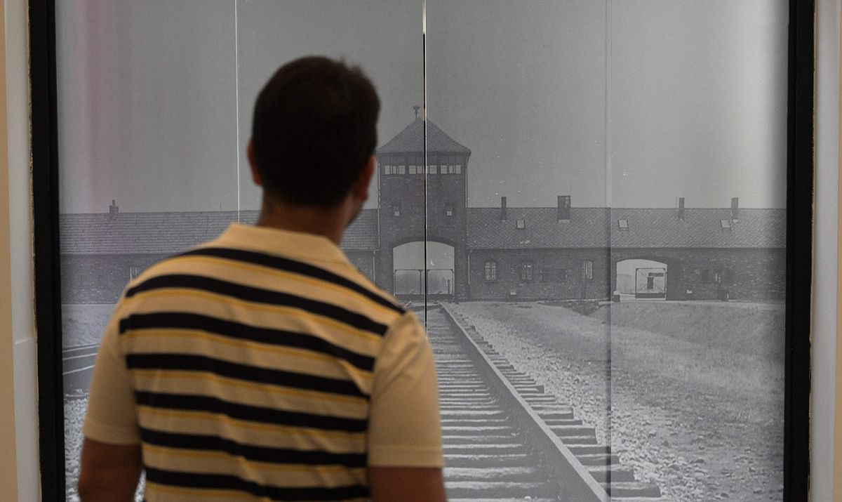 A man watches an automatic door with the image of the Auschwitz concentration camp at the Holocaust Museum in Buenos Aires on 29 November. Photo: AFP