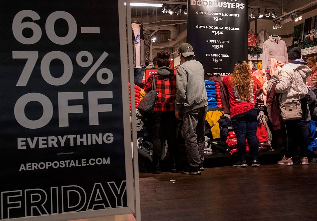 Shoppers at a clothing store, look for early bargains as the Black Friday sales begin on Thanksgiving Day in Los Angeles, California on 28 November. Photo: AFP