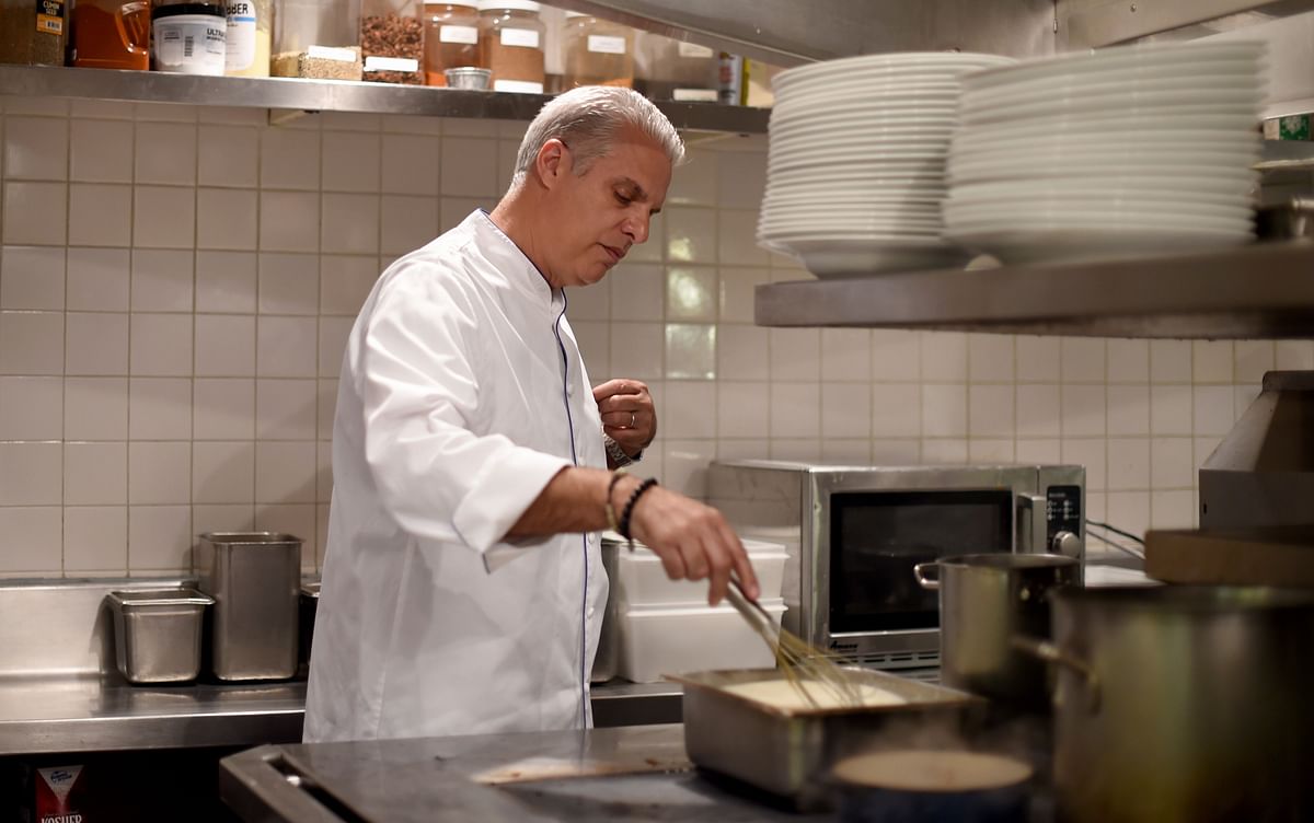 In this file photograph taken on 16 May 2016, Eric Ripert, chef and co-owner of Le Bernardin in New York City works in the kitchen of his restaurant in New York on 16 May 2016. Photo: AFP