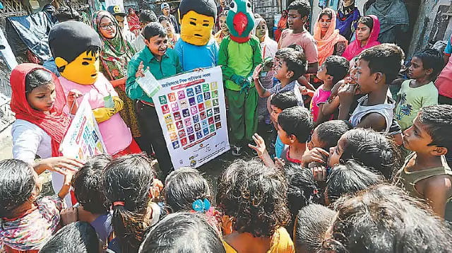 Shafikul Islam Khan campaigns with the volunteers dressed in Meena, Raju and Mithu costume. Photo: Prothom Alo
