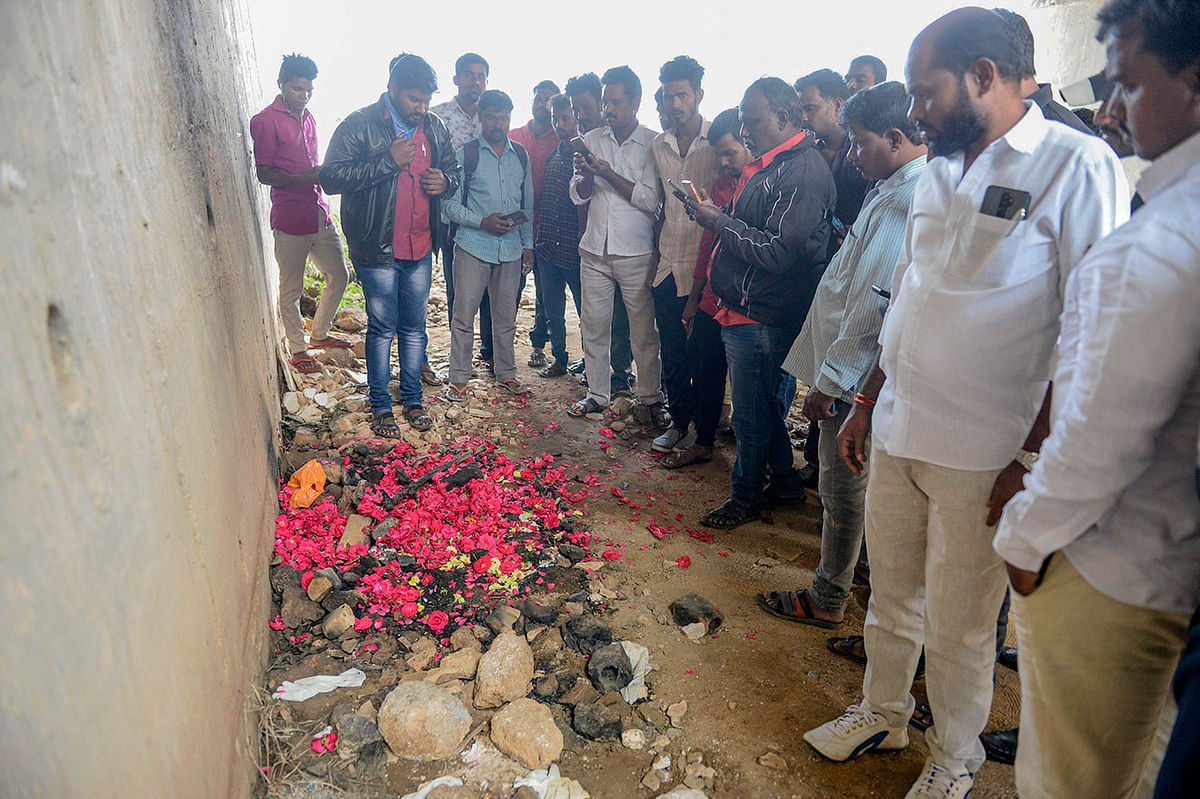 People gather around the site where the 27-year-old veterinarian`s body was found after she was allegedly gang-raped and murdered by four men at Shadnagar on 6 December, 2019. Indian police on December 6 shot dead four detained gang-rape and murder suspects as they were re-enacting their alleged crime, prompting outrage but also wild celebrations. Photo: AFP