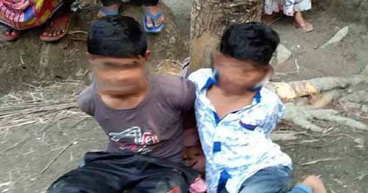 Police on Sunday arrested two people for tying two minors to a tree and torturing them on suspicion of stealing a mobile phone in Pirojpur`s Bhandaria upazila. Photo: UNB