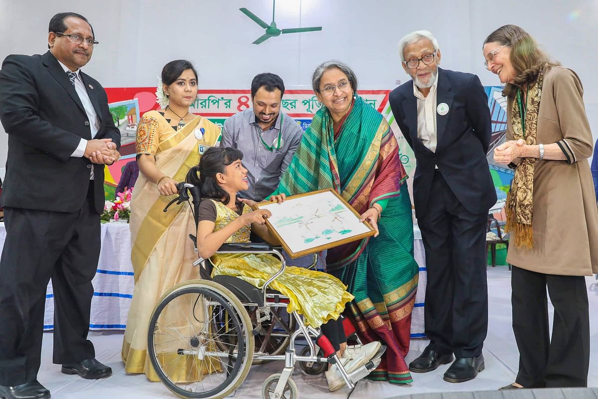 Education minister Dipu Moni (3rd R) and Valerie Taylor, founder and coordinator of Centre for the Rehabilitation of the Paralysed (CRP), pose for picture in a programme to celebrate 40th anniversary of CRP in Dhaka on 7 December 2019. Photo: Saiful Islam