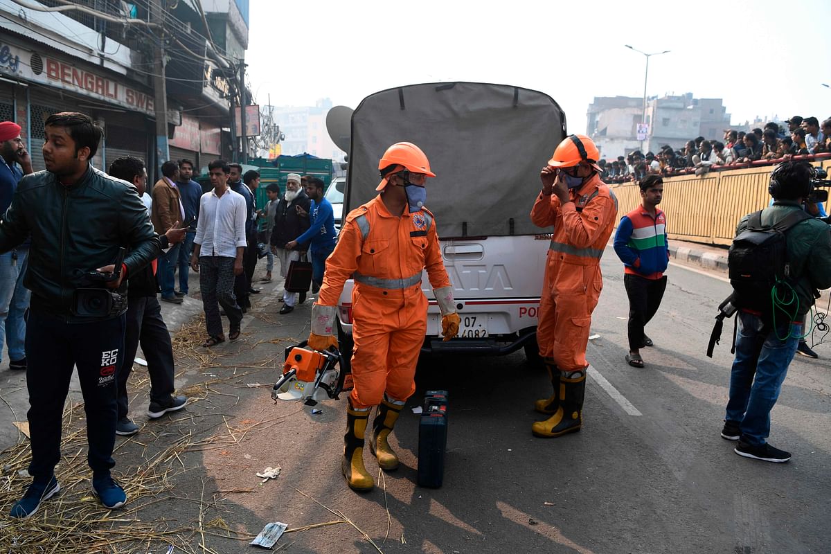 National Disaster Response Force personnel gear up as they prepare to access a factory site after a fire broke out, in Anaj Mandi area of New Delhi on 8 December 2019. Photo: AFP