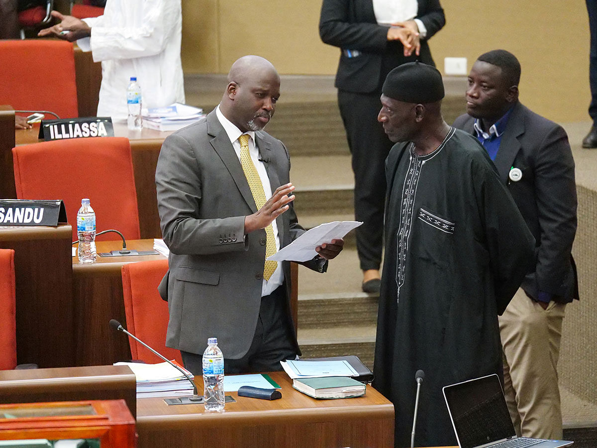 The Gambia justice minister Abubacarr Tambadou discusses the bill with a member of Parliament at the national assembly in Banjul, Gambia on 2 December 2019. Photo: Reuters