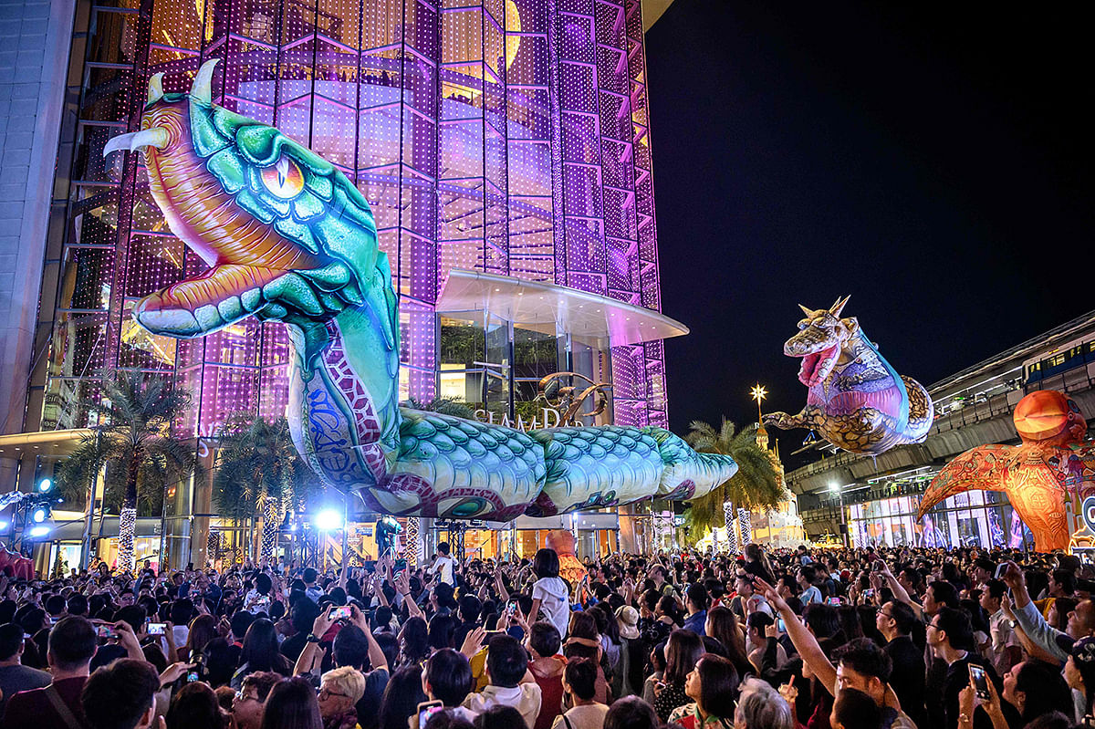 Giant balloons representing mythical creatures fly over the crowd during `The Quest of Adventure in the World of Magical Tales` Christmas show performed by French group Plasticiens Volants in Bangkok on 8 December 2019. Photo: AFP