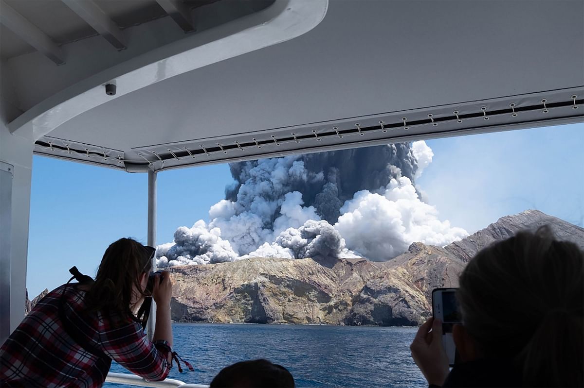 This handout photograph courtesy of Michael Schade shows the volcano on New Zealand`s White Island spewing steam and ash moments after it erupted on 9 December 2019. Photo: AFP