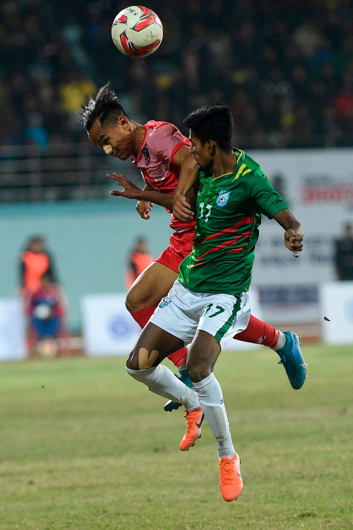 Nepal`s midfielder Sunil Bal (L) fights for the ball with Bangladesh`s defender Riyadul Hasan (R) during the football match between Nepal and Bangladesh at the 13th South Asian Games (SAG) in Kathmandu on 8 December 2019. Photo: AFP