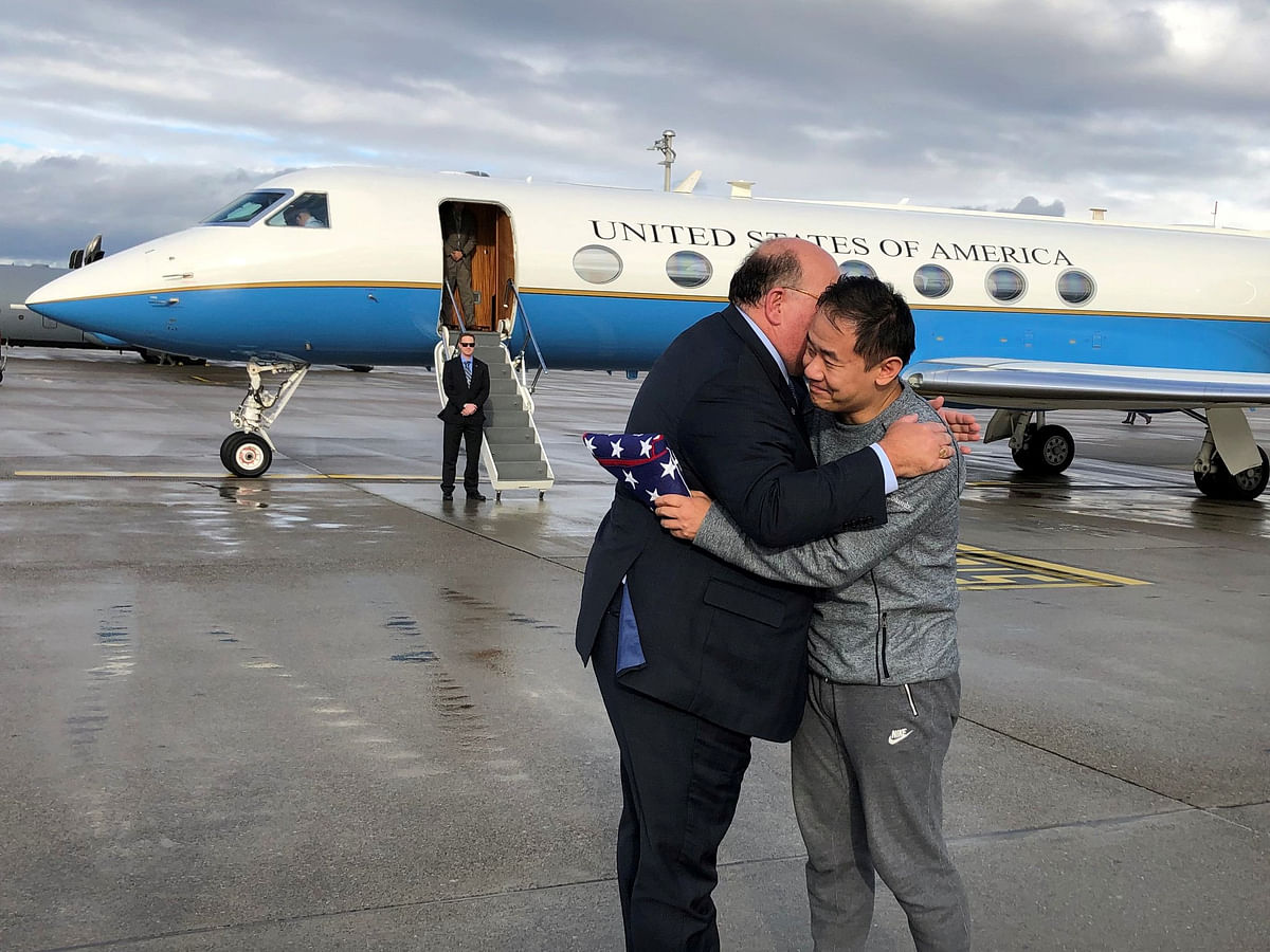US Ambassador to Switzerland Edward McMullen greets Xiyue Wang in Zurich, Switzerland December 7, 2019. US
