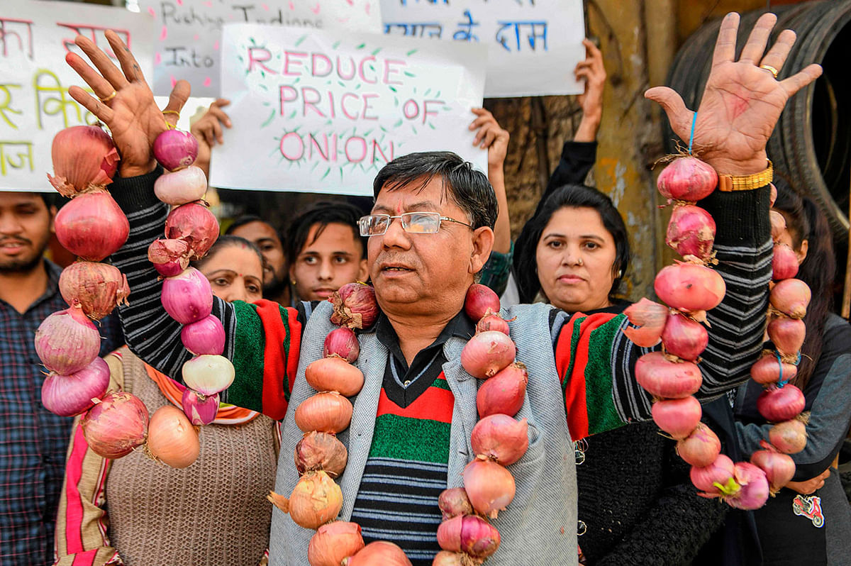 Social workers hold placards and garlands of onions to protest against the rise of onions` prices, during a demonstration in Amritsar on 7 December 2019. Photo: AFP