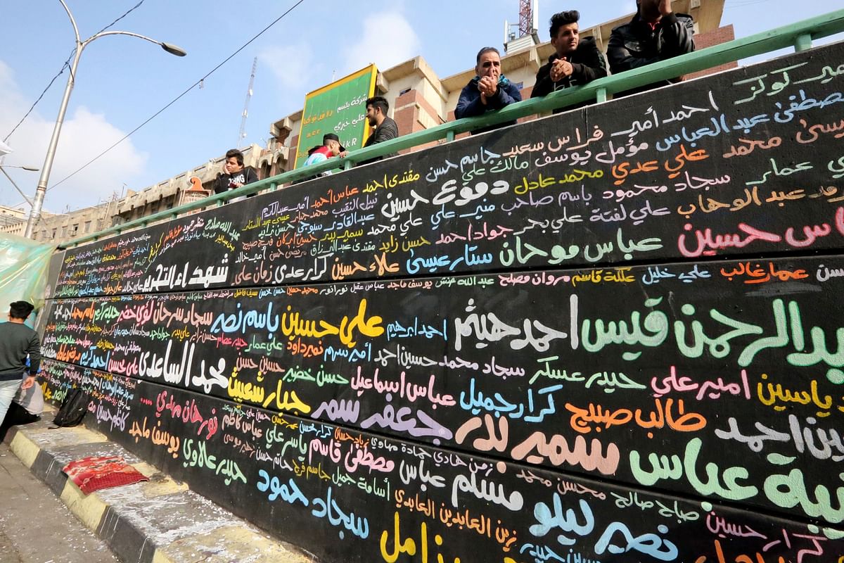 A memorial mural bearing names of demonstrators killed during ongoing anti-government protests is seen in Tahrir square in the capital Baghdad on 8 December 2019. Thousands attended angry protests in Baghdad and southern Iraq today, grieving but defiant after 20 of them were killed in an attack the previous day, in dramatic developments which threaten to derail the anti-government rallies rocking Iraq since October, the largest and deadliest grassroots movement in decades. Photo: AFP