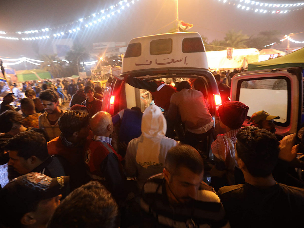 An ambulance arrives in Tahrir square after unidentified men attacked an anti-government protest camp in Baghdad late on 6 December 2019. Photo: AFP