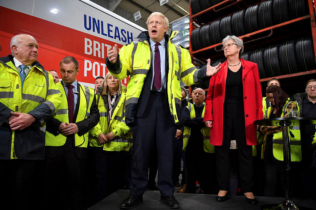 Britain`s prime minister and Conservative leader Boris Johnson talks at a Q&A session next to Chair of the Vote Leave Gisela Stuart and CEO Alan Ferguson during a general election campaign visit to Fergusons Transport in the town of Washington, west of Sunderland, Britain on 9 December. Photo: Reuters
