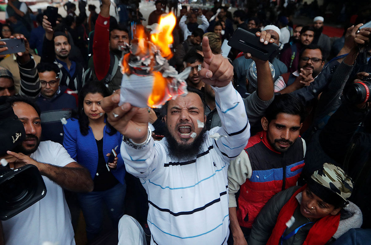 Demonstrators burn copies of Citizenship Amendment Bill, a bill that seeks to give citizenship to religious minorities persecuted in neighbouring Muslim countries, during a protest in New Delhi, India, on 10 December 2019. Photo: Reuters