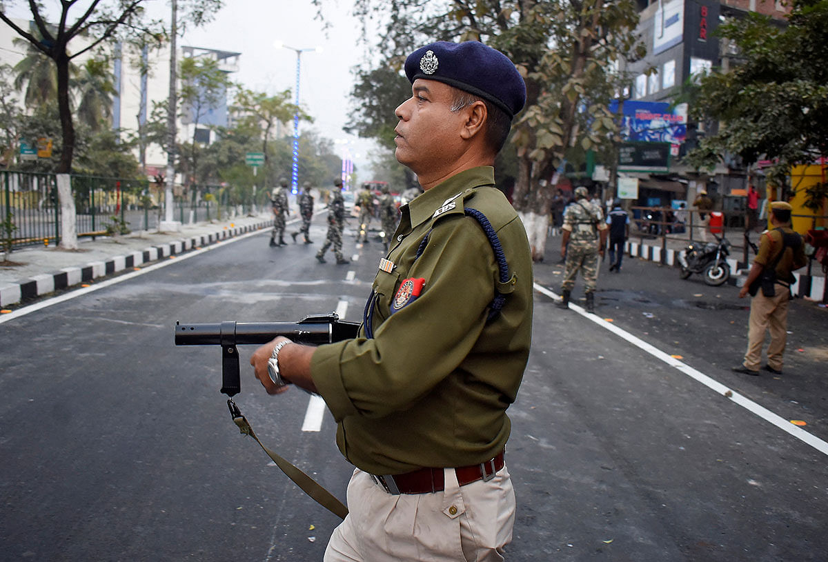 A police officer holds a tear gas gun during a protest against Citizenship Amendment Bill (CAB), a bill that seeks to give citizenship to religious minorities persecuted in neighbouring Muslim countries, in Guwahati, India, on 10 December 2019. Photo: Reuters