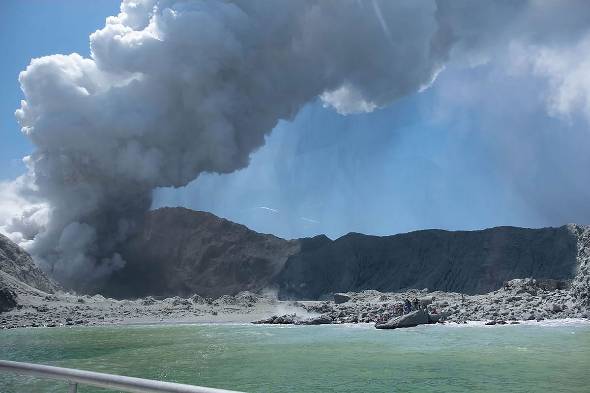 This handout photograph courtesy of Michael Schade shows the volcano on New Zealand`s White Island spewing steam and ash minutes following an eruption on 9 December 2019. Photo: AFP