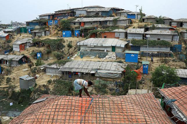 A Rohingya refugee repairs the roof of his shelter at the Balukhali refugee camp in Cox‘s Bazar, Bangladesh, on 5 March 2019. Reuters File Photo