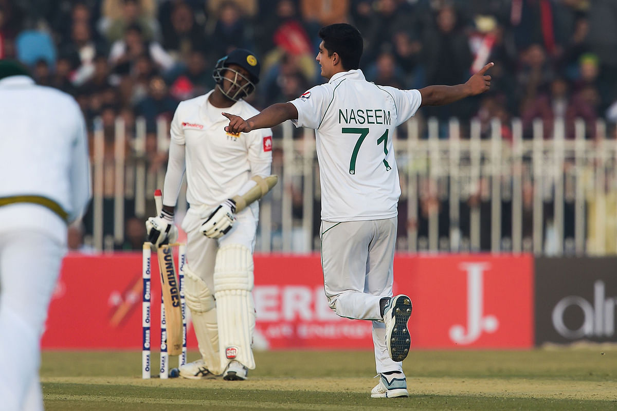 Pakistan`s Naseem Shah (R) celebrates after dismissing Sri Lanka`s Angelo Mathews (L) during the first day of the first Test cricket match between Pakistan and Sri Lanka at the Rawalpindi Cricket Stadium in Rawalpindi on 11 December, 2019.