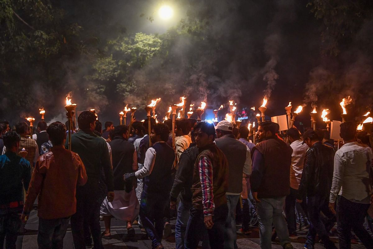 Indian youth congress (IYC) members hold torches as they gather to protest against the government's Citizenship Amendment Bill (CAB), during a demonstration in New Delhi on 11 December, 2019. Photo: AFP