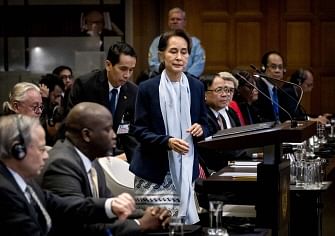 Myanmar`s state counsellor Aung San Suu Kyi (C) stands before the UN`s International Court of Justice on 11 December 2019 in the Peace Palace of The Hague, on the second day of her hearing on the Rohingya genocide case. Aung San Suu Kyi appears at the UN`s top court today, a day after the former democracy icon was urged to `stop the genocide` against Rohingya Muslims.