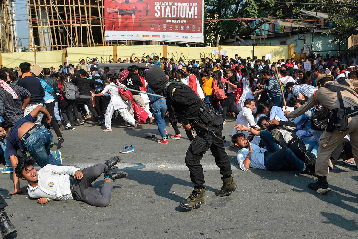 Security personnel use batons to disperse students protesting against the governments Citizenship Amendment Bill (CAB), in Guwahati on 11 December, 2019. Photo: AFP