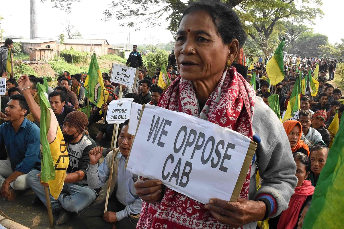 Indigenous People`s Front of Tripura (IPFT) hold placards as they protest against the government`s Citizenship Amendment Bill, in Tripura on 9 December 2019. Photo: AFP