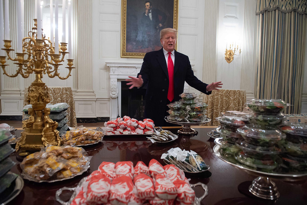 US President Donald Trump speaks alongside fast food he purchased for a ceremony honoring the 2018 College Football Playoff National Champion Clemson Tigers in the State Dining Room of the White House in Washington, DC on 14 January 2019. photo: AFP