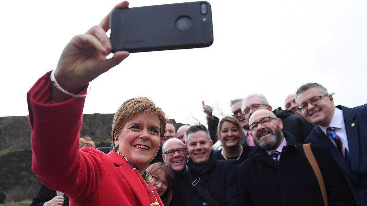 Scottish National Party (SNP) leader and Scotland`s First Minister Nicola Sturgeon poses for a selfie photograph on arrival for an election campaign event in Edinburgh, Scotland on 11 December 2019. Photo: AFP