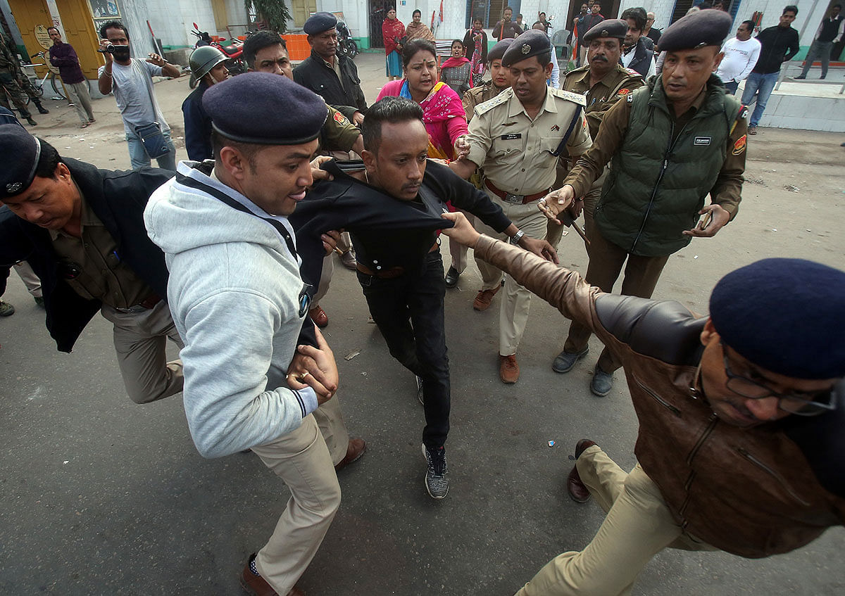 Policemen detain a demonstrator during a protest after India`s parliament passed Citizenship Amendment Bill (CAB), in Agartala, India, on 12 December 2019. Photo: Reuters