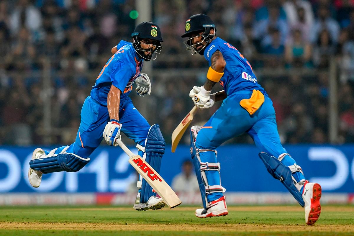 India`s captain Virat Kohli (L) and teammate Kannaur Lokesh Rahul run between the wickets during the third T20 international cricket match of a three-match series between India and West Indies at the Wankhede Stadium in Mumbai on 11 December 2019. Photo: AFP