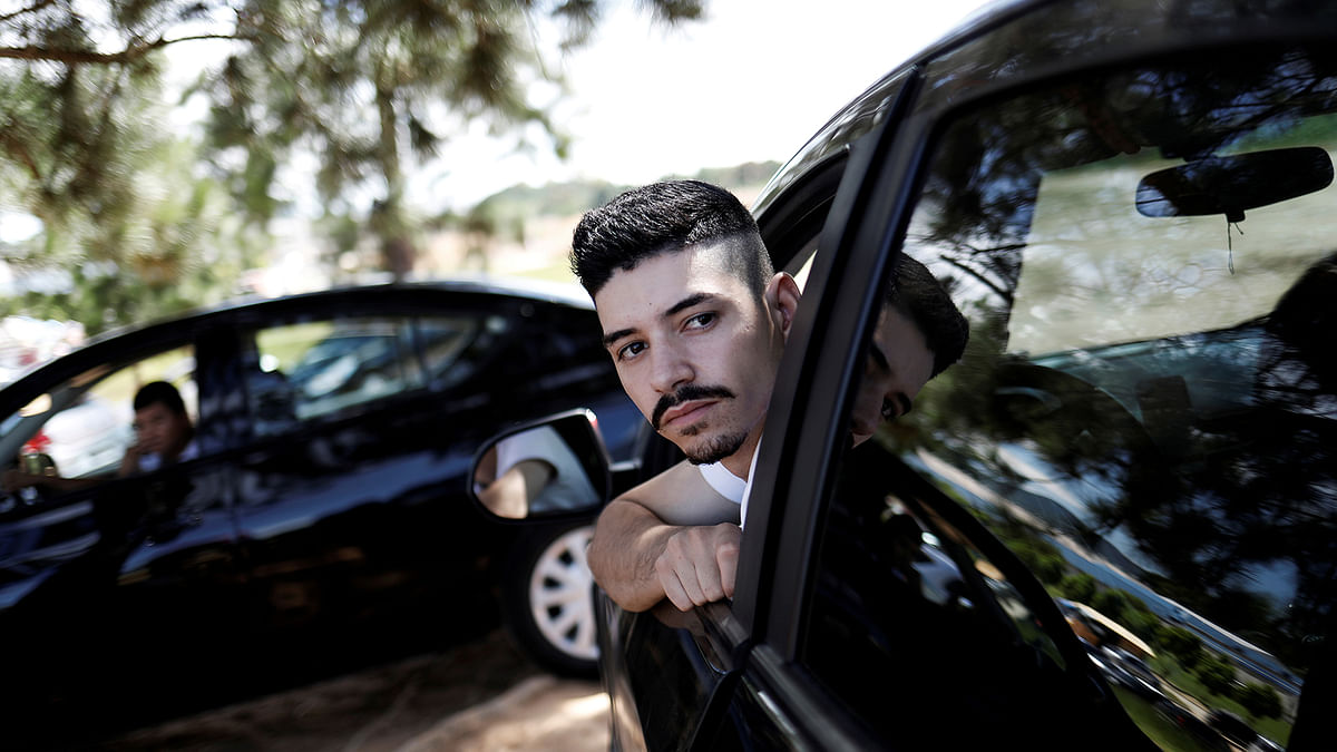 Uber drivers sit in their cars as they wait for passengers in Sao Paulo. Photo: Reuters