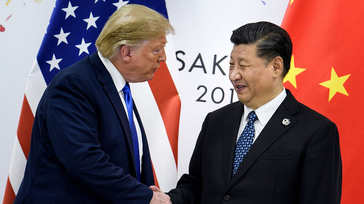 In this file China`s president Xi Jinping (R) shakes hands with US president Donald Trump before a bilateral meeting on the sidelines of the G20 Summit in Osaka on 29 June. Photo: AFP