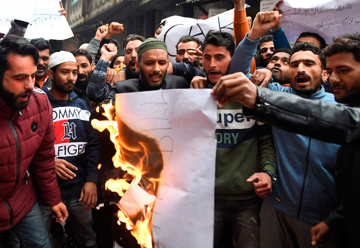 Muslims demonstrators shout slogans as they burn placards during a protest against the government`s Citizenship Amendment Bill (CAB) in Amritsar on 13 December, 2019. Photo: AFP
