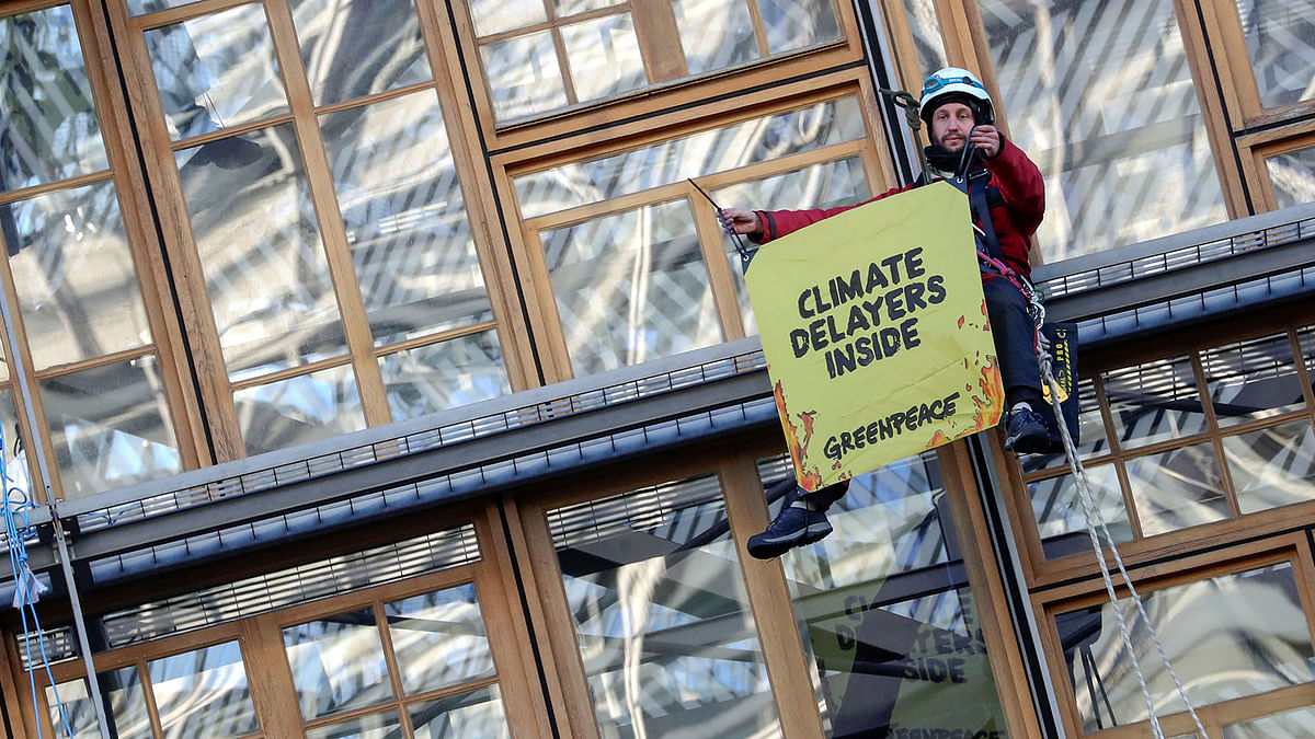 A climate change activist holds a placard during a Greenpeace protest, outside the EU Council headquarters, ahead of an EU leaders summit in Brussels, Belgium on 12 December 2019. Photo: Reuters