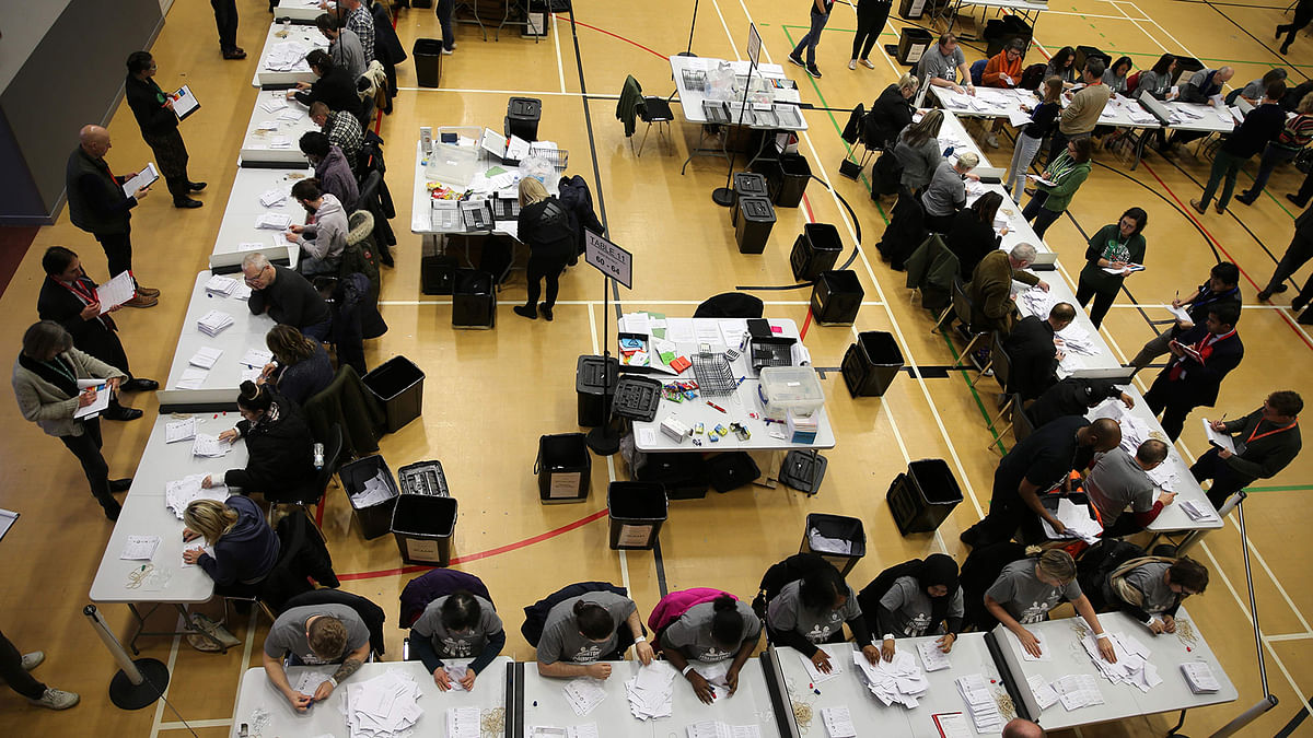 Count staff sort the ballot papers in the count centre in Islington where Britain`s opposition Labour Party leader Jeremy Corbyn hopes to retain his seat, in north London, on 12 December 2019. Photo: AFP