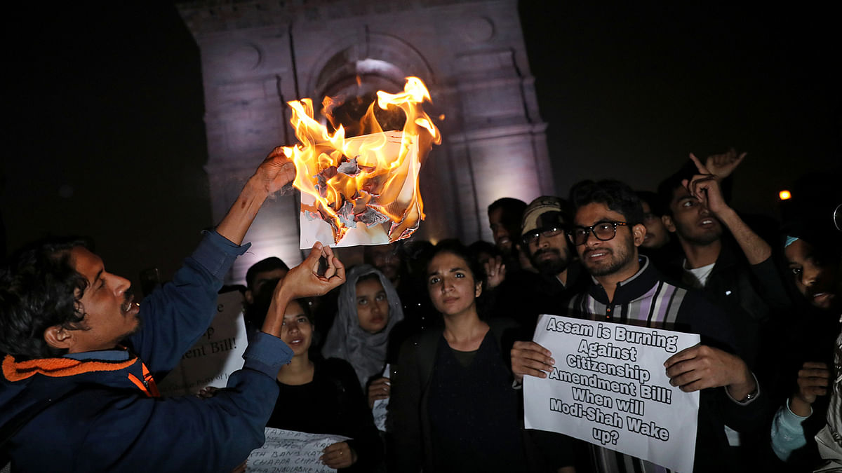 Demonstrators burn a copy of Citizenship Amendment Bill, a bill that seeks to give citizenship to religious minorities persecuted in neighbouring Muslim countries, during a protest in New Delhi, India, on 12 December 2019. Photo: Reuters