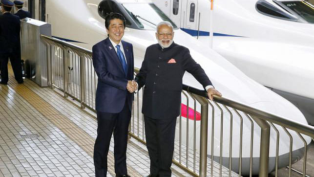 Japanese prime minister Shinzo Abe (L) shakes hand with India prime minister Narendra Modi. Reuters File Photo