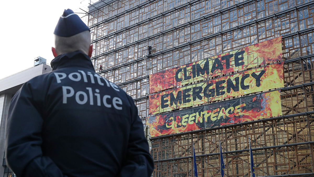 A police officer looks on a displayed banner ahead of an EU leaders summit in Brussels, Belgium on 12 December 2019. Photo: Reuters
