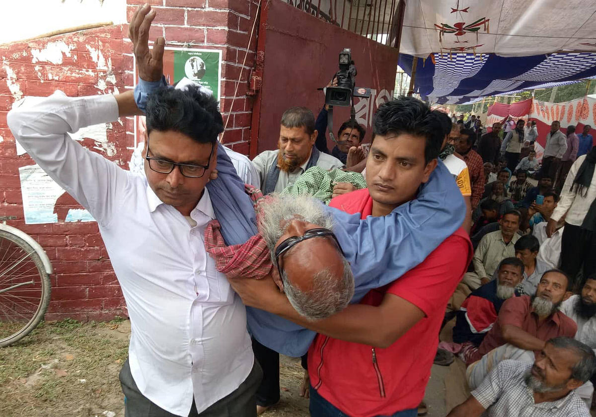 A worker is being taken to hospital. He fell sick during a hunger strike by the state-owned jute mills` workers demanding salary and other allowances in Katakhali, Paba, Rajshahi on 12 December 2019. Photo: Shahidul Islam