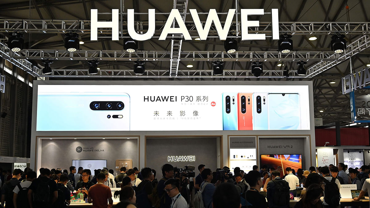 This file photo taken on 11 June 2019 shows people gathering at a Huawei stand during the Consumer Electronics Show, Ces Asia 2019 in Shanghai. Whether Beijing and Washington reach a trade deal or not, China is already speeding up efforts to break its reliance on a country that is both its most important economic partner and biggest adversary. Photo: AFP